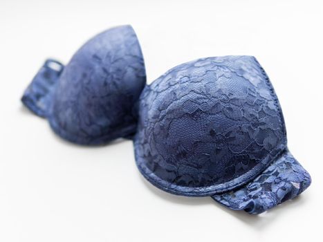 Bra made of blue laces on white background. Elegant underwear without shoulder straps.