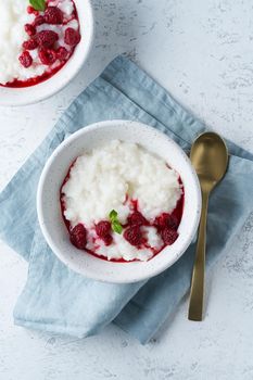 Rice Pudding. Vegan Coconut diet breakfast with coconut milk, raspberry, scandinavian minimalism