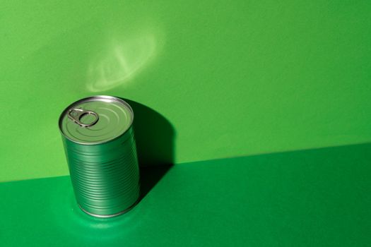 Canned food tin on green studio background