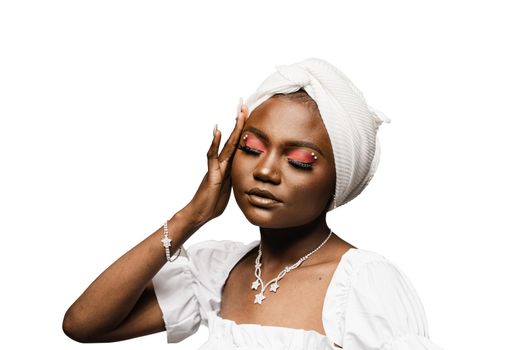 Beauty portrait of black muslim woman weared white dress and headscarf on white background. Softness and wellness of body and skin.