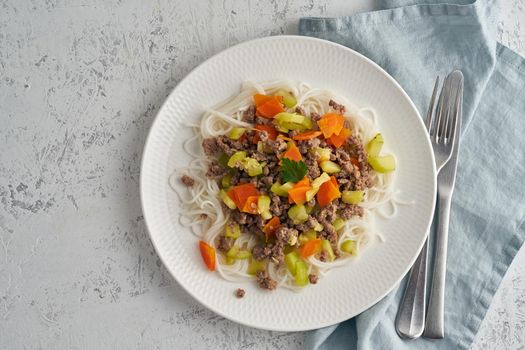 Delicious rice pasta with mince meat and vegetables, top view