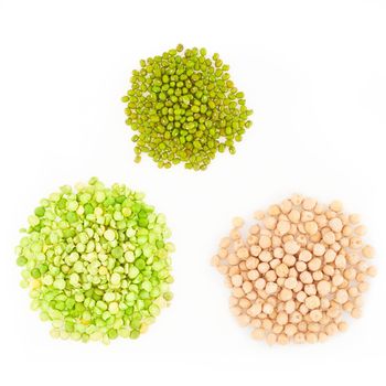 three kinds of raw dried legumes - chickpeas, mung bean, green peas, isolated on white background