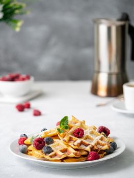 Belgian waffles with raspberries, blueberries, curd and coffee