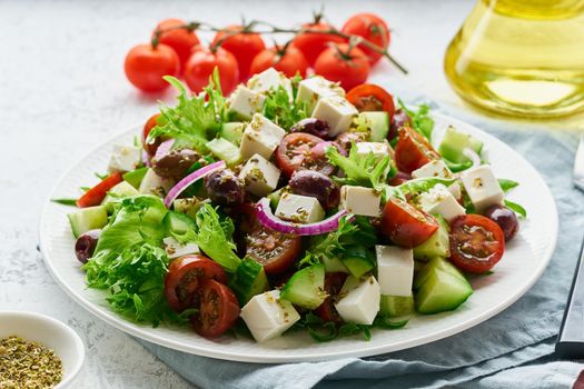 Greek Salad with feta and tomatoes, dieting food on white background closeup