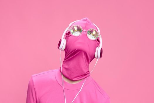 Creative crazy pink photo on a pink background with pink clothes and accessories, cyberpunk concept and conceptual art photography