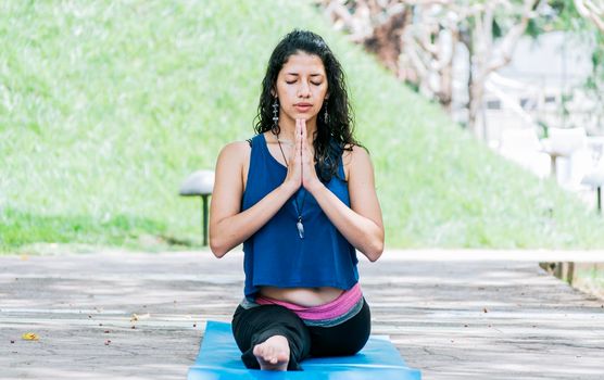 Girl sitting doing split meditation yoga outdoors, woman doing side split yoga outdoors, young woman doing side split yoga