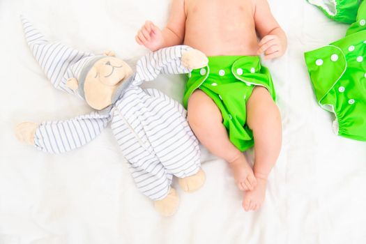 Reusable diaper on the baby copy space . An article about reusable diapers. Saving on diapers. Concern for the environment. Eco-products.
