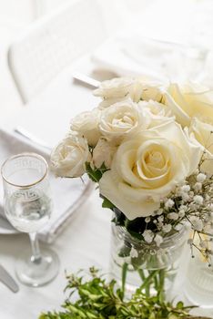 The wedding decor. Wedding teble decoration with white roses, closeup