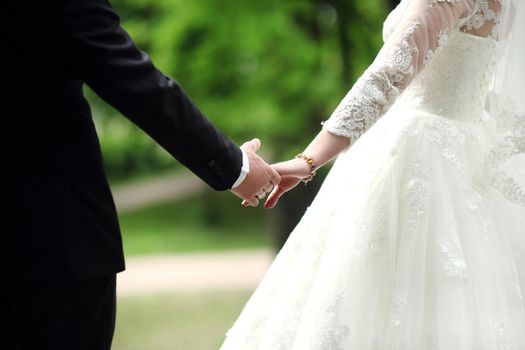 Closeup view of married couple holding hands