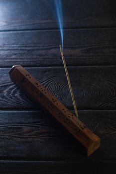 Focus on incense stick and smoke.