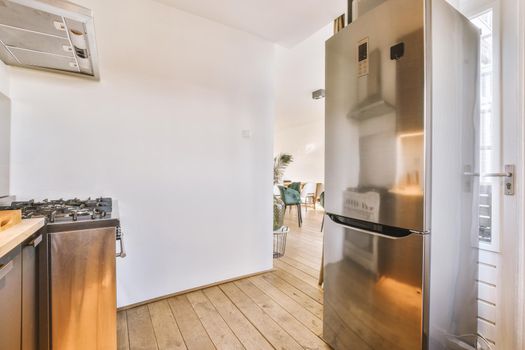 Corner kitchen with fridge and hood