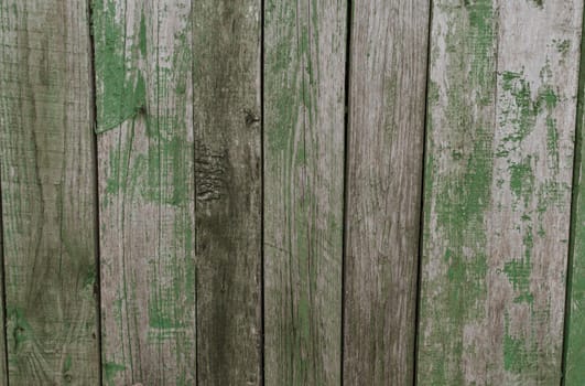 old shabby gray fence made of wooden boards