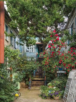 Backyard of old house in Krasnodar. Old fashioned architecture and small garden of apartment building. Russia.