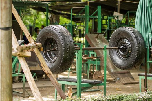 BANGKOK, THAILAND - October 23, 2012. Outdoor gym in Lumpini park. Exercise equipment made of old truck tires and metal bars.