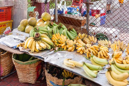 BANGKOK, THAILAND - October 23, 2012. Bananas and pomelos on stall at marketplace. Traditional local fruits on street market.