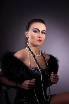 woman in fur boa with pearl beads retro syle