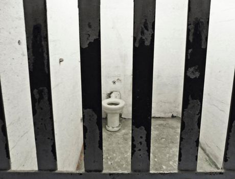 alcatraz cell with bars and hygienic sanitary
