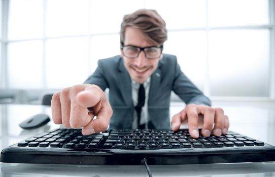 man pointing at something with finger and using computer keyboard