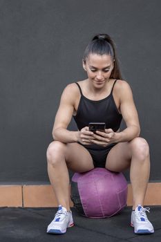 Sportswoman using smartphone during break