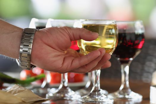Male person take glass of alcoholic drink from bar, cooling beverage, champagne or wine