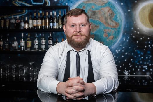 Bearded Adult Caucasian Looking Professional Bartender Portrait in Nightclub