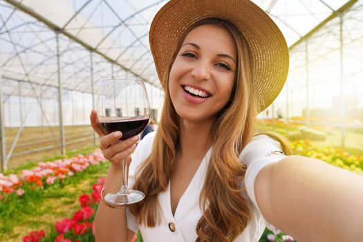 Selfie photo of attractive young woman outdoors holding glass drinking wine on weekend activity