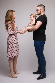 Portrait of happy family from three people posing at camera.