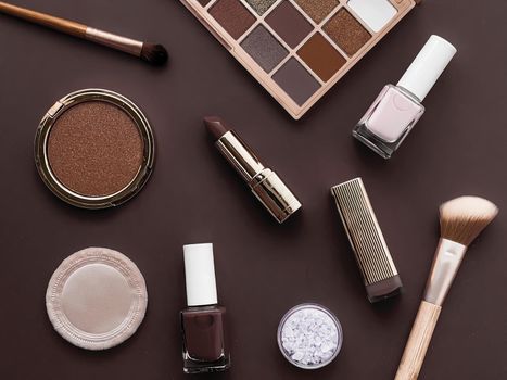Beauty, make-up and cosmetics flatlay design with copyspace, cosmetic products and makeup tools on brown background, girly and feminine style