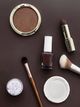 Beauty, make-up and cosmetics flatlay design with copyspace, cosmetic products and makeup tools on brown background, girly and feminine style