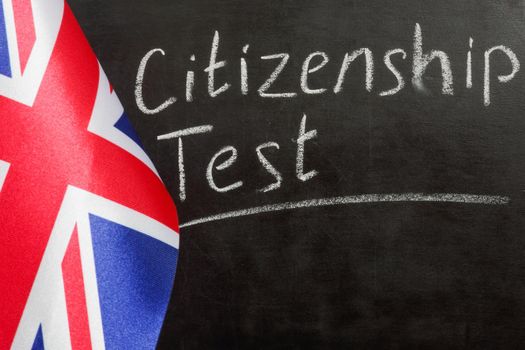 UK flag and citizenship test on chalkboard.