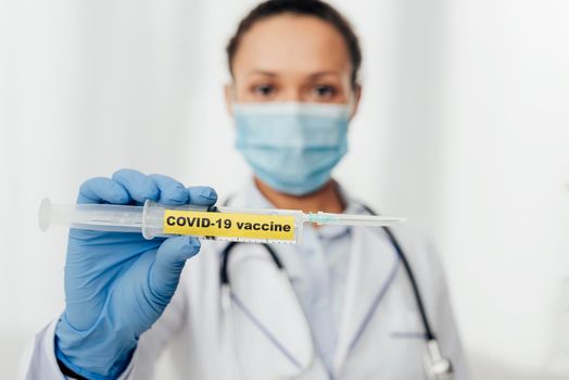 close up doctor holding covid19 vaccine