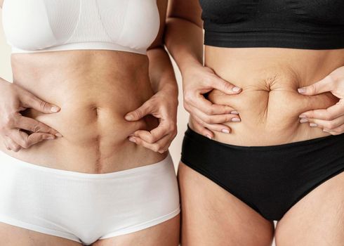 close up women holding belly