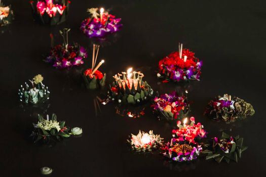 Krathongs - ritual vessels with candles or lamps. Floral composition for religious festival Loy Krathong. Traditional celebration with floating offering to gods.