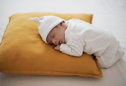 cute baby sleeping yellow pillow