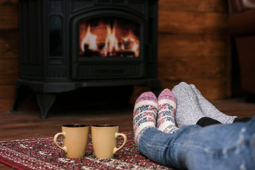 couples warming feet fireplace