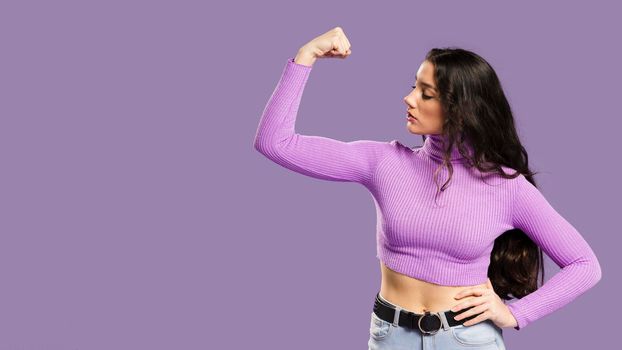 woman showing muscles having violet top sideways