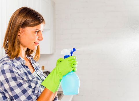 young woman cleaning house