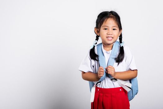 Asian adorable toddler smiling happy wearing student thai uniform red skirt standing