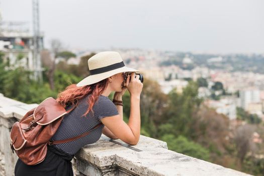 female tourist with camera balcony