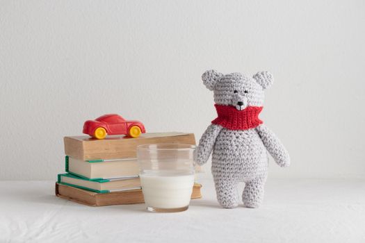 Crochet knitting cute teddy bear with books and a toy