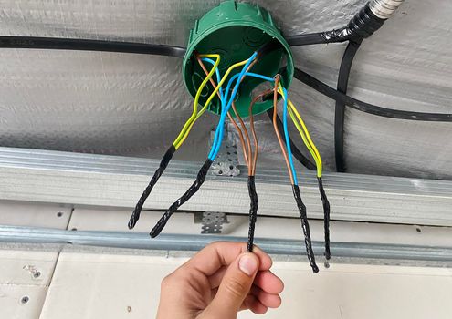 Electrical wiring of the junction box, installation, twisting of the box by an electrician.