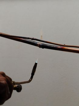 repairman welding copper pipes