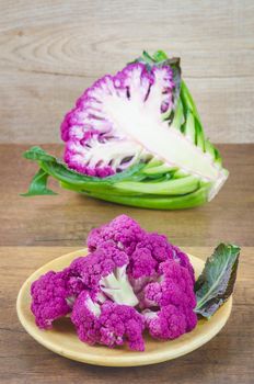 Freshness Purple Cauliflower on wooden background.