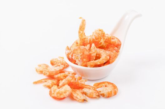 Dried shrimp in white spoon isolated on white.