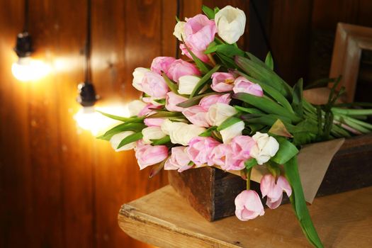 Tulip flower bouquet on a wooden table background