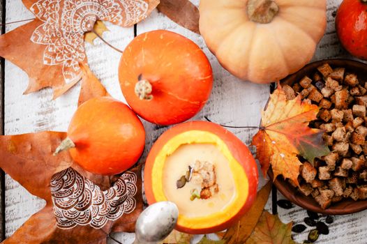 pumpkin cream soup in autumn scenery