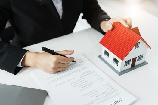 Law, agreement, contract, mortgage, woman holding a pen, reading the contract document in buying a house to see the interest rate and asking for the limit to assess the risk before buying a house