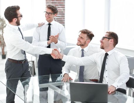 business colleagues shaking hands in the workplace