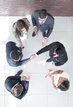 top view.business partners shaking hands