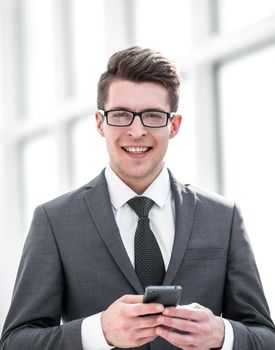 smiling businessman with smartphone